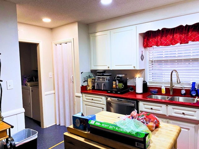 107 Mulberry St, Inman, SC 29349 - kitchen with dishwashing machine, washing machine and dryer, white cabinetry, dark countertops, and a textured ceiling