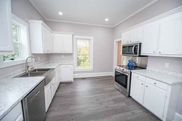 708 E Main St, Union, SC 29379 - kitchen with appliances with stainless steel finishes, white cabinets, wood finished floors, recessed lighting, and ornamental molding