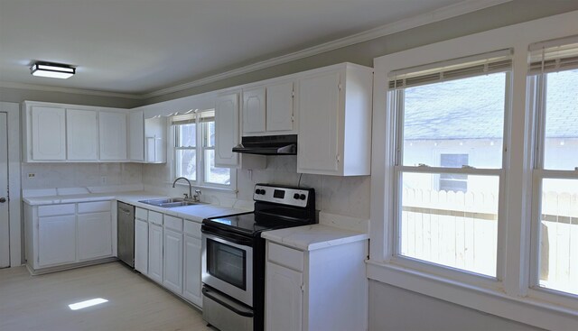 210 James St, Union, SC 29379 - kitchen featuring appliances with stainless steel finishes, under cabinet range hood, white cabinets, and crown molding