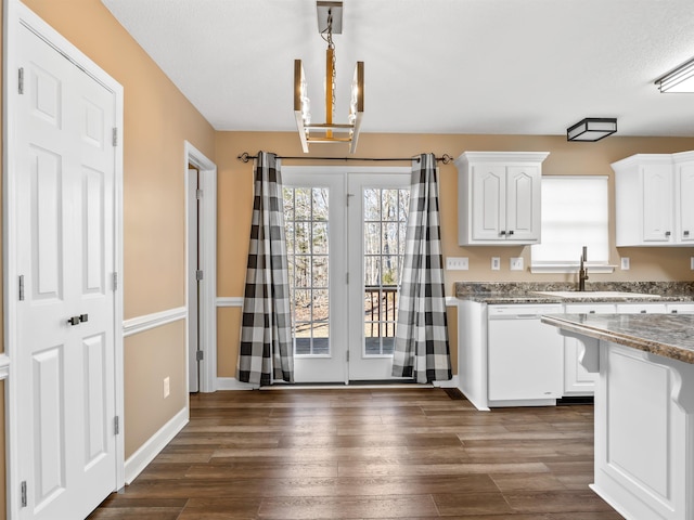 160 Blake Garrison Dr, Roebuck, SC 29376 - kitchen with white dishwasher, white cabinets, a chandelier, dark wood-style flooring, and decorative light fixtures