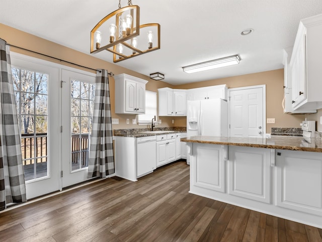 160 Blake Garrison Dr, Roebuck, SC 29376 - kitchen featuring white appliances, a peninsula, white cabinetry, dark wood-type flooring, and recessed lighting