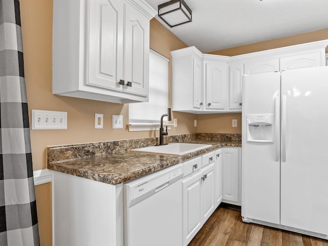 160 Blake Garrison Dr, Roebuck, SC 29376 - kitchen featuring white appliances, white cabinets, dark countertops, and dark wood-style flooring