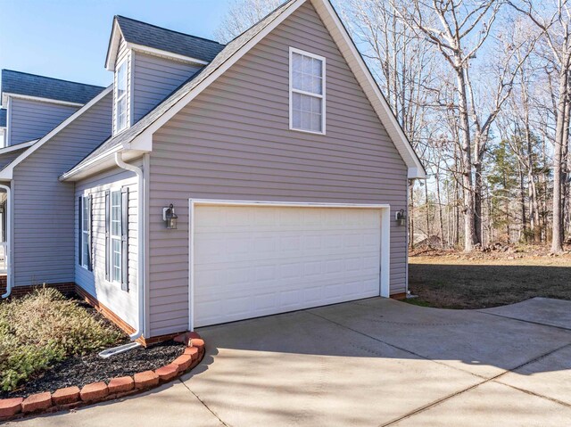 160 Blake Garrison Dr, Roebuck, SC 29376 - view of side of property featuring driveway, a shingled roof, and a garage