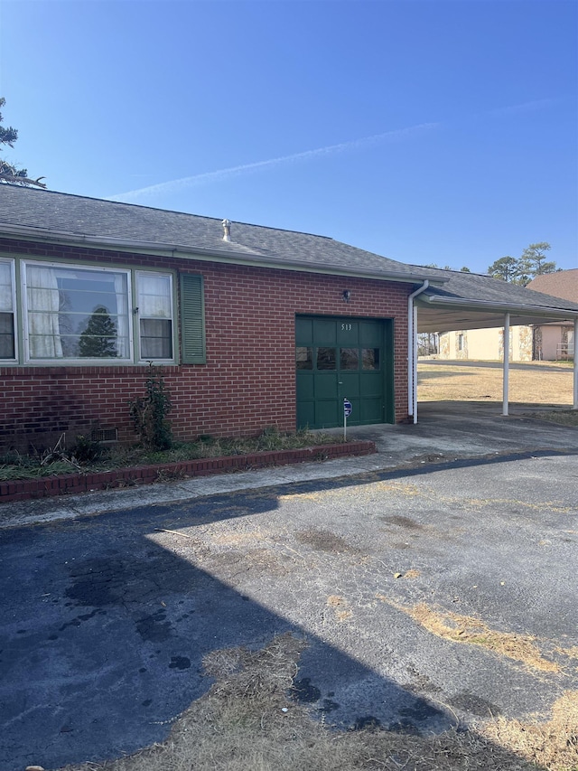 513 Peach Orchard Rd, Union, SC 29379 - view of property exterior featuring a garage, brick siding, driveway, and a shingled roof