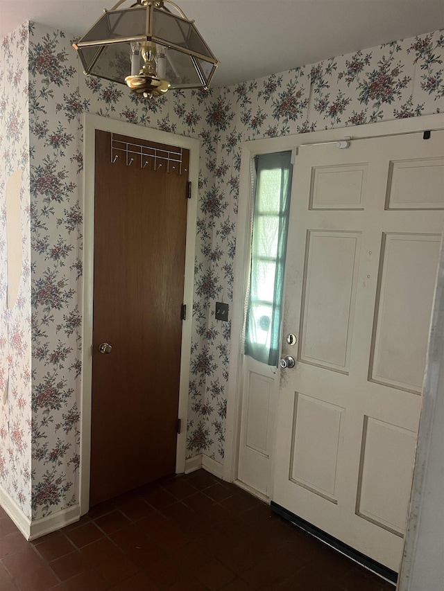 513 Peach Orchard Rd, Union, SC 29379 - entryway with wallpapered walls and dark tile patterned floors