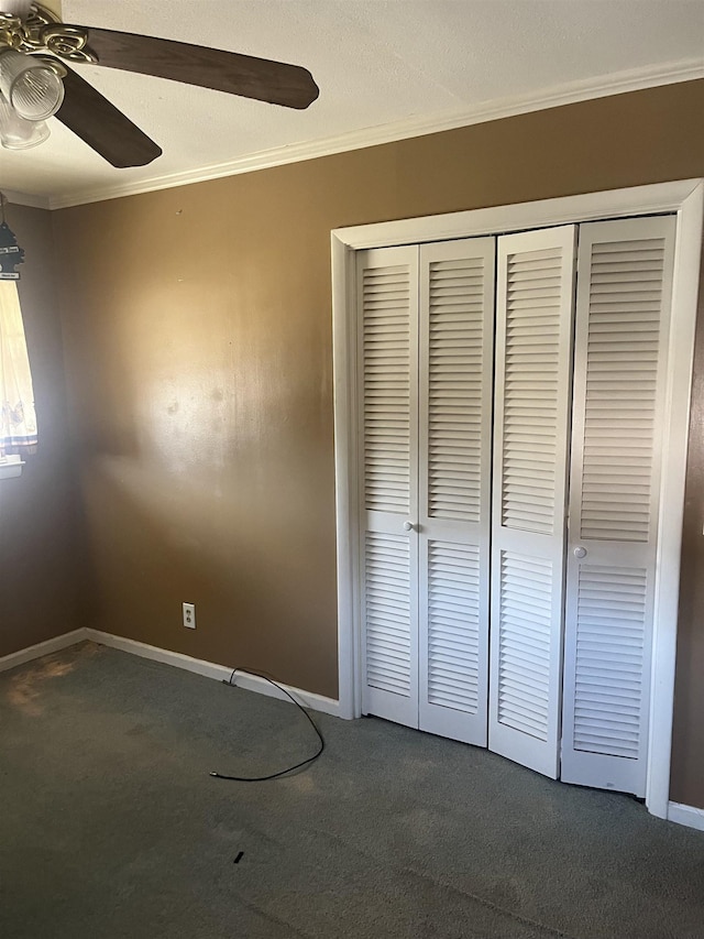513 Peach Orchard Rd, Union, SC 29379 - unfurnished bedroom featuring ornamental molding, dark carpet, a closet, and a ceiling fan