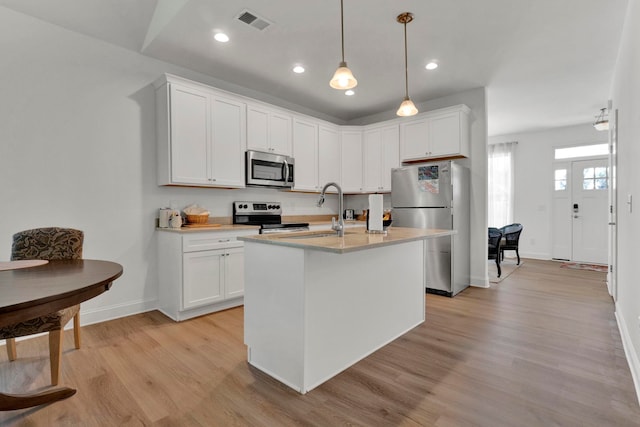 2297 Davenport Ct, Moore, SC 29369 - kitchen with stainless steel appliances, light wood-type flooring, light countertops, white cabinets, and recessed lighting