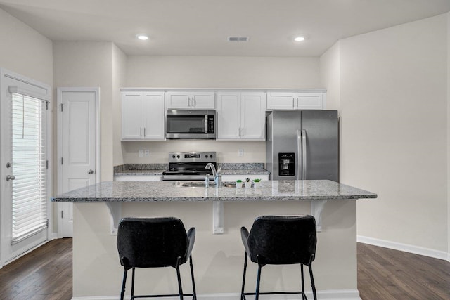 14 Sunriff Ct, Greer, SC 29651 - kitchen with appliances with stainless steel finishes, dark wood-style floors, a kitchen bar, and recessed lighting
