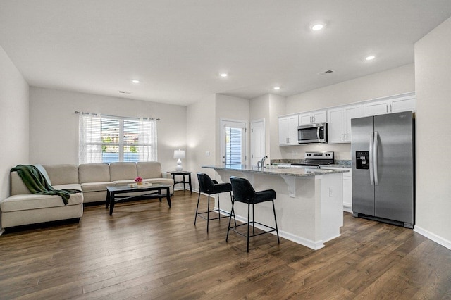 14 Sunriff Ct, Greer, SC 29651 - kitchen featuring appliances with stainless steel finishes, a center island with sink, healthy amount of natural light, a breakfast bar area, and recessed lighting