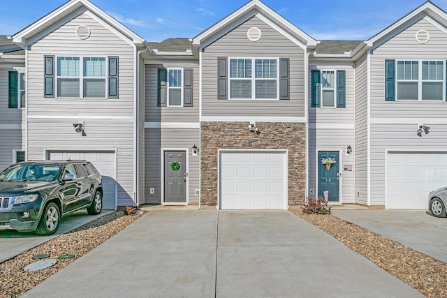 14 Sunriff Ct, Greer, SC 29651 - townhome / multi-family property featuring stone siding, concrete driveway, and a garage