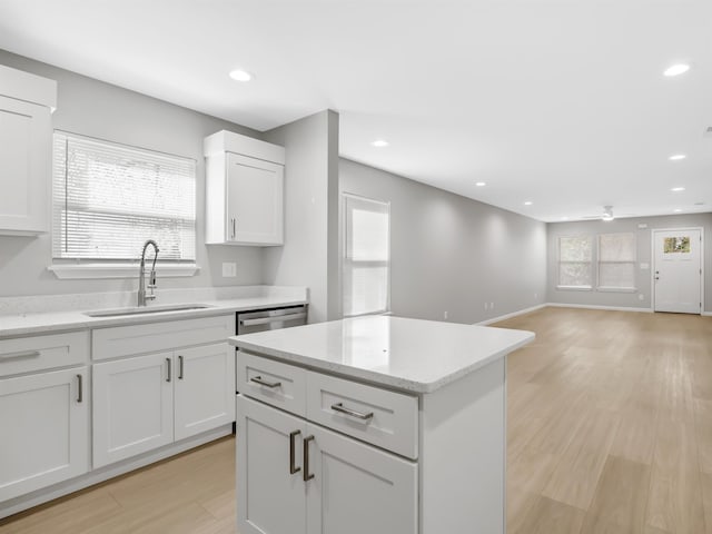 218 Caulder Cir, Spartanburg, SC 29306 - kitchen with recessed lighting, light wood finished floors, white cabinets, a ceiling fan, and a kitchen island