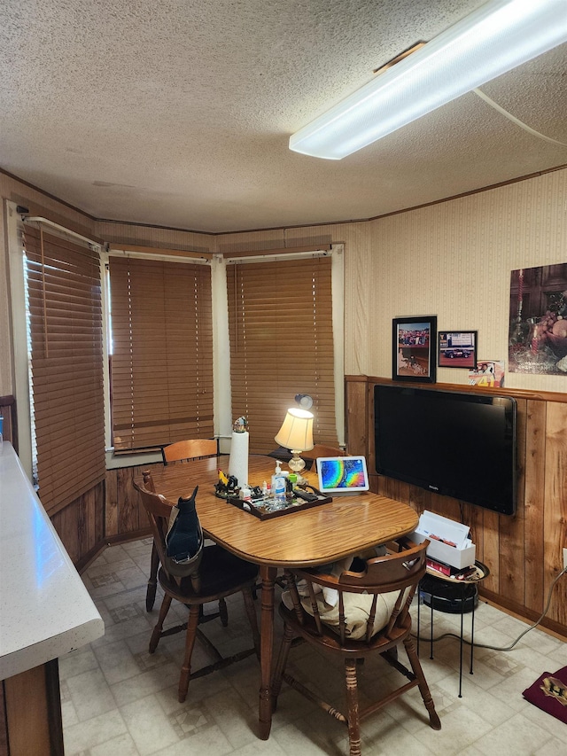 248 W Wood St, Spartanburg, SC 29303 - dining area featuring wooden walls, light flooring, and a textured ceiling