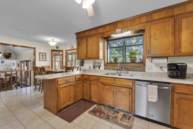 1114 Edisto Dr, Spartanburg, SC 29302 - kitchen featuring stainless steel dishwasher, light countertops, a peninsula, and brown cabinets