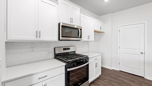 1312 Salix Ct, Spartanburg, SC 29303 - kitchen with stainless steel appliances, backsplash, white cabinets, and dark wood-style floors