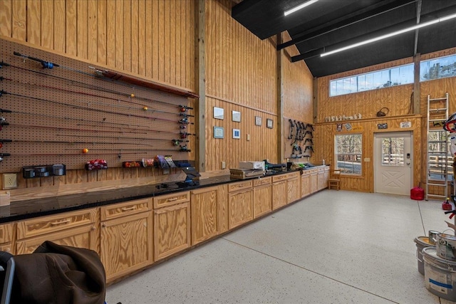 3664 River Rd, Union, SC 29379 - misc room with a high ceiling, wood walls, and dark aggregate flooring