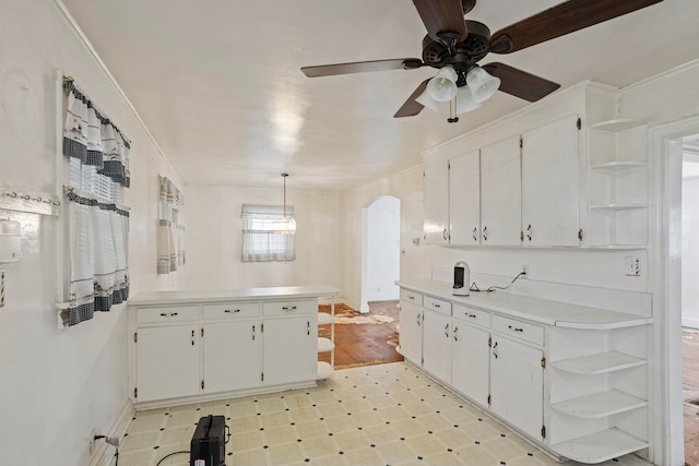 371 Tucapau Rd, Wellford, SC 29385 - kitchen featuring open shelves, a peninsula, arched walkways, light flooring, and white cabinetry