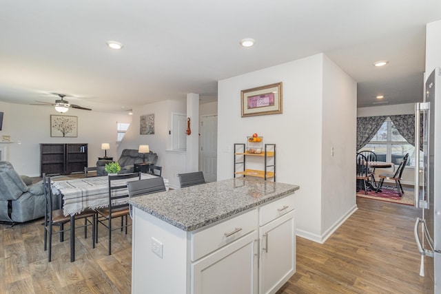 3812 Sapling Ln, Moore, SC 29369 - kitchen with plenty of natural light, white cabinets, light wood-type flooring, a kitchen island, and recessed lighting