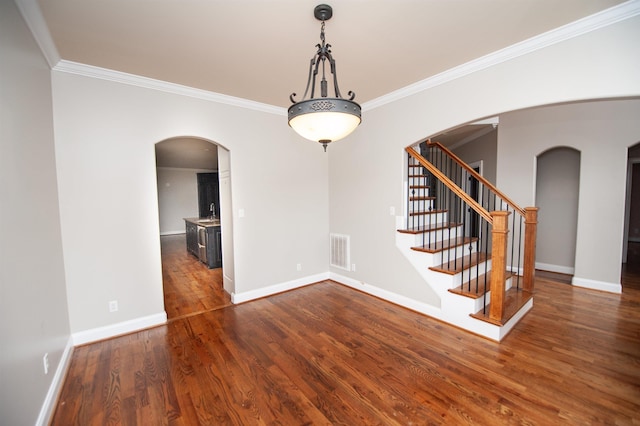 311 Burro Ct, Boiling Springs, SC 29316 - spare room with crown molding, arched walkways, wood finished floors, and stairs