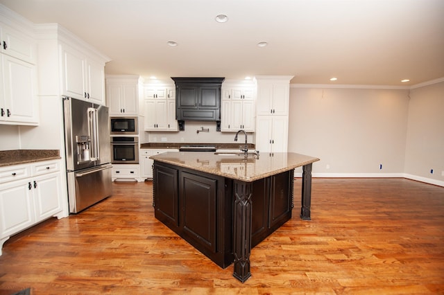 311 Burro Ct, Boiling Springs, SC 29316 - kitchen with appliances with stainless steel finishes, white cabinets, light wood-type flooring, range hood, and recessed lighting