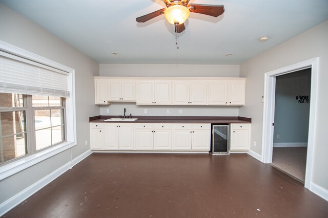 311 Burro Ct, Boiling Springs, SC 29316 - kitchen featuring wine cooler, finished concrete floors, dark countertops, and white cabinets