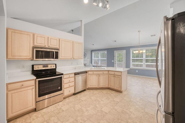 106 Brandi Starr Ct, Greer, SC 29651 - kitchen featuring light brown cabinets, stainless steel appliances, a chandelier, light countertops, and lofted ceiling