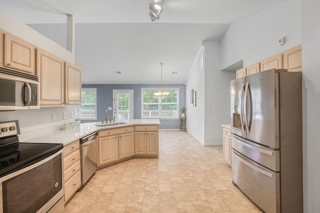 106 Brandi Starr Ct, Greer, SC 29651 - kitchen featuring appliances with stainless steel finishes, light brown cabinetry, a peninsula, and healthy amount of natural light