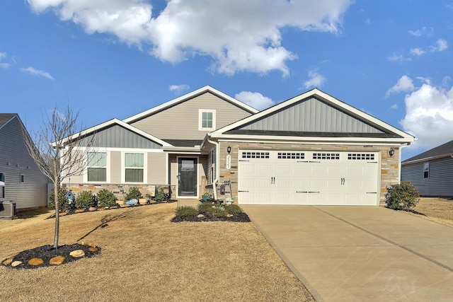 2325 Caffry Ln, Boiling Springs, SC 29316 - craftsman-style house featuring stone siding, board and batten siding, concrete driveway, an attached garage, and a front lawn
