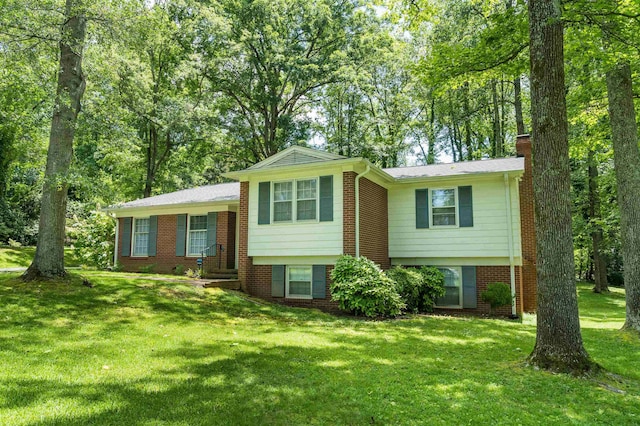 1105 Partridge Rd, Spartanburg, SC 29302 - split level home featuring a chimney, a front yard, and brick siding