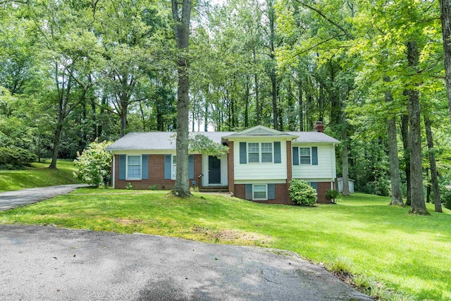 1105 Partridge Rd, Spartanburg, SC 29302 - split level home featuring a chimney, brick siding, and a front lawn
