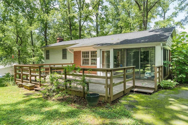 1105 Partridge Rd, Spartanburg, SC 29302 - rear view of house featuring a chimney, a wooden deck, a lawn, and roof with shingles