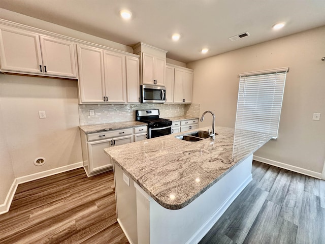 637 Grays Creek Rd, Spartanburg, SC 29303 - kitchen featuring appliances with stainless steel finishes, white cabinetry, dark wood-type flooring, decorative backsplash, and recessed lighting