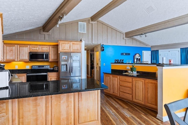 1109 Hemlock Dr, Shelby, NC 28150 - kitchen featuring appliances with stainless steel finishes, a peninsula, wood finished floors, a textured ceiling, and dark stone counters