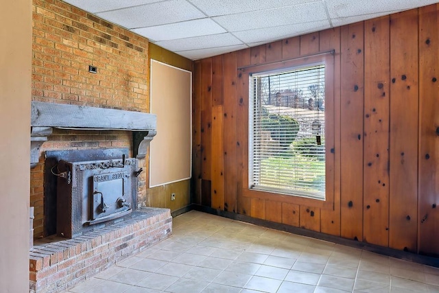 1109 Hemlock Dr, Shelby, NC 28150 - unfurnished living room with wood walls, tile patterned floors, and a paneled ceiling
