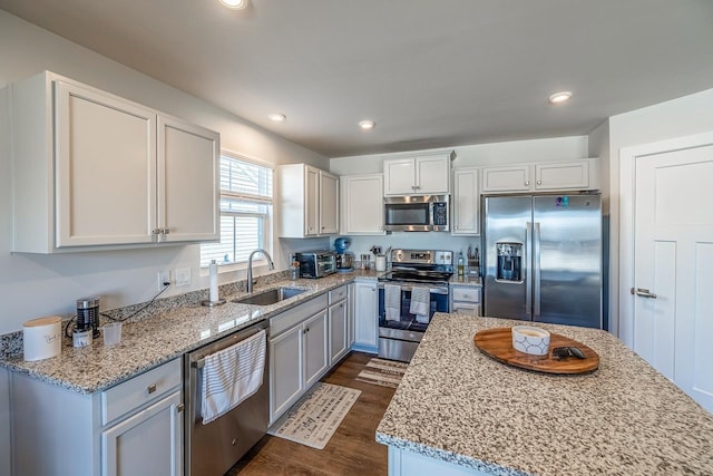 2086 Wexley Dr, Boiling Springs, SC 29316 - kitchen featuring appliances with stainless steel finishes, dark wood-style floors, light stone countertops, recessed lighting, and white cabinets