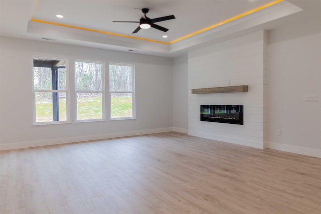114 Robin Hill Dr, Inman, SC 29349 - unfurnished living room with a raised ceiling, a ceiling fan, light wood-type flooring, a large fireplace, and recessed lighting