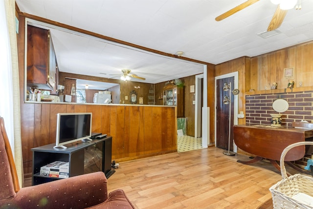 163 Railroad St, Enoree, SC 29335 - living area featuring ceiling fan, wooden walls, and light wood-style floors