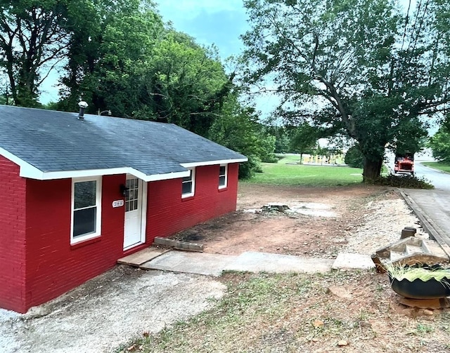 210 Sunny St, Spartanburg, SC 29302 - view of side of home with roof with shingles and brick siding