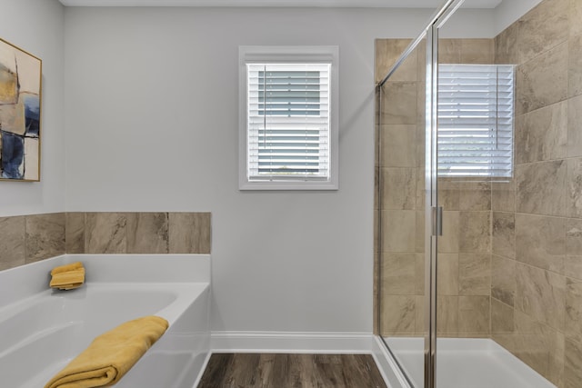 1034 Silverbend Trl, Duncan, SC 29334 - bathroom featuring a bath, a shower stall, and wood finished floors