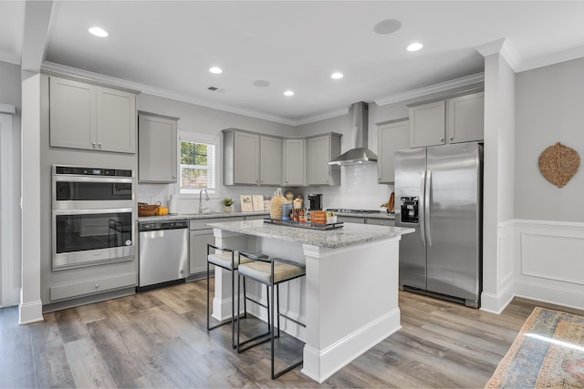 1034 Silverbend Trl, Duncan, SC 29334 - kitchen featuring stainless steel appliances, wall chimney range hood, gray cabinets, crown molding, and a kitchen island