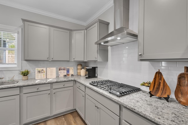 1034 Silverbend Trl, Duncan, SC 29334 - kitchen featuring wall chimney exhaust hood, stainless steel gas cooktop, gray cabinetry, ornamental molding, and backsplash