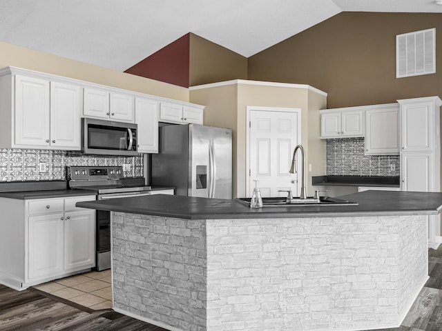 461 Candleglow Dr, Boiling Springs, SC 29316 - kitchen featuring appliances with stainless steel finishes, dark countertops, white cabinetry, high vaulted ceiling, and a spacious island