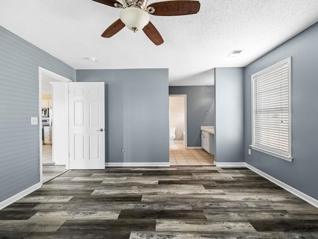461 Candleglow Dr, Boiling Springs, SC 29316 - unfurnished bedroom featuring wood finished floors, ensuite bath, a textured ceiling, and ceiling fan