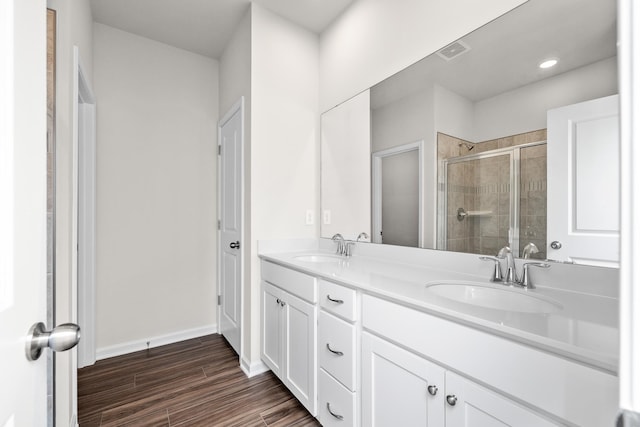 305 Novelty Dr, Greer, SC 29651 - bathroom with double vanity, a shower stall, and wood finished floors