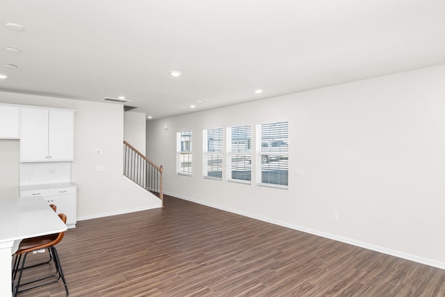305 Novelty Dr, Greer, SC 29651 - unfurnished living room with dark wood-style flooring, recessed lighting, and stairway