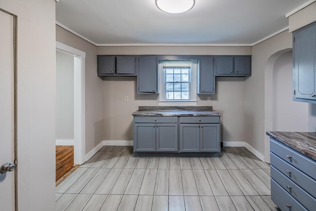 107 Ravenscroft St, Union, SC 29379 - kitchen with arched walkways, dark countertops, wood finish floors, and ornamental molding