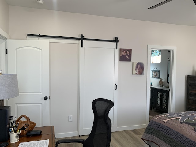 138 Lowe Rd, Chesnee, SC 29323 - bedroom with a barn door, light wood finished floors, and connected bathroom