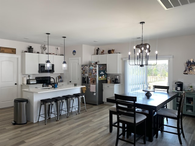 138 Lowe Rd, Chesnee, SC 29323 - dining room with light wood-style flooring and a chandelier