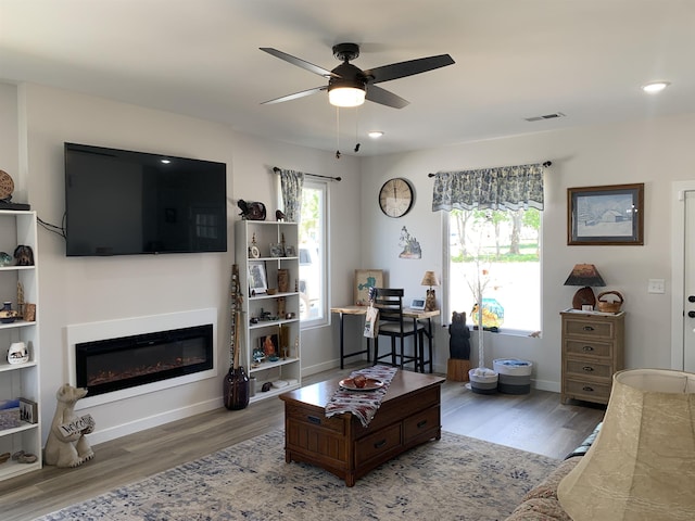 138 Lowe Rd, Chesnee, SC 29323 - living room featuring a ceiling fan, wood finished floors, a glass covered fireplace, and recessed lighting