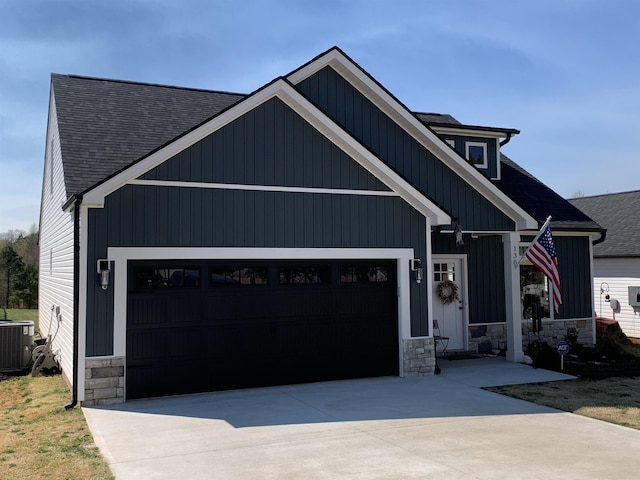 138 Lowe Rd, Chesnee, SC 29323 - modern inspired farmhouse with a shingled roof, stone siding, concrete driveway, and an attached garage