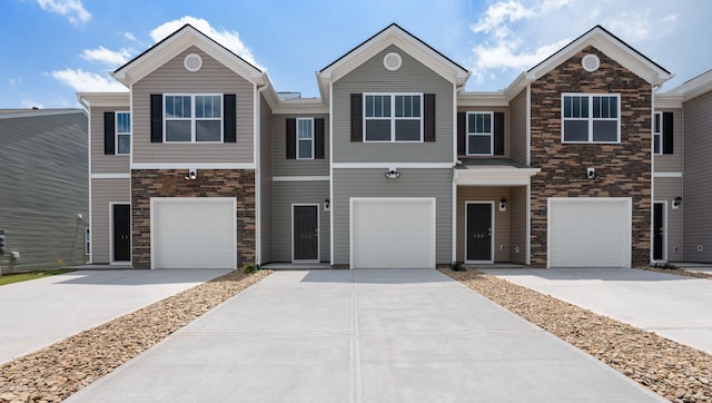 110 Sunriff Ct, Greer, SC 29651 - townhome / multi-family property featuring driveway, stone siding, and an attached garage